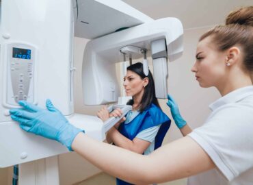 Young woman patient standing in x-ray machine. Panoramic radiography